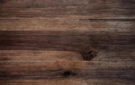 Close-up of a natural dark wooden surface showing organic grain patterns and rustic tones. Ideal for backgrounds, design projects, and texture overlays in creative compositions. photo