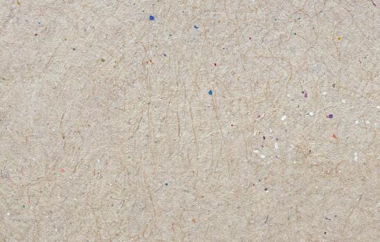 Rough recycled paper texture with visible fibers, small colored specks, and organic pattern, ideal for eco design projects or sustainable product branding. photo