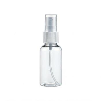 An empty small see through spray bottle isolated on white photo