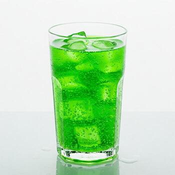 A glass of lime soda and ice isolated on white photo