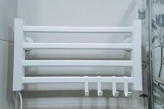 Introducing a Stylish White Towel Rack featuring Hooks, designed specifically to enhance Bathroom Organization while also adding an elegant touch to your space, keeping towels neatly arranged photo