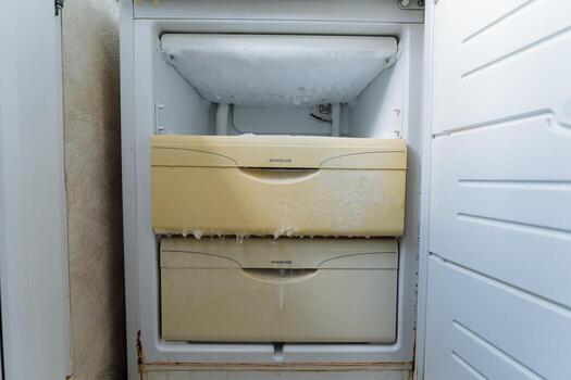 An aging freezer that exhibits significant ice buildup can signal underlying issues that require prompt attention and regular maintenance to ensure optimal performance and efficiency in your kitchen photo