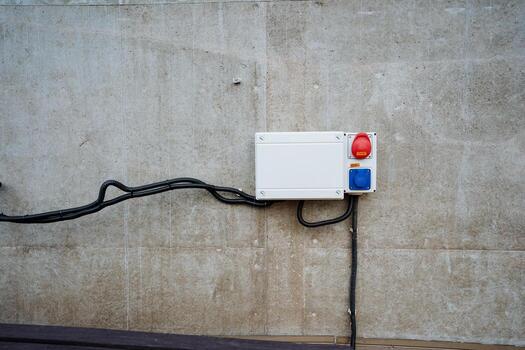 This advanced Industrial Control Box features Warning Lights securely mounted on a sturdy Concrete Wall, designed for safety and ease of use in various automation and engineering applications photo