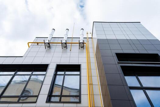 Modern Architecture that showcases Industrial Features along with an intricate Pipework design prominently displayed on the Facade of the buildings, creating a visually striking cityscape photo