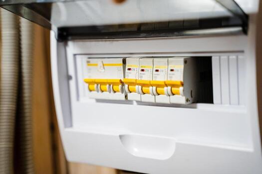 This is a detailed closeup view of an electrical circuit breaker panel that features multiple switches, commonly found in modern homes, showcasing its intricate design and functionality photo