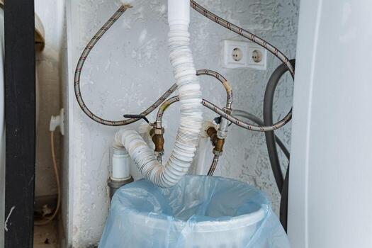 The plumbing setup is designed with flexible hoses and a comprehensive drainage system specifically tailored for various appliances used in households, ensuring efficient operation and convenience photo