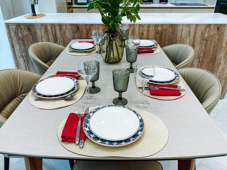 An elegant dining table setting features stylish decor, exquisite glassware, and a tastefully designed tablecloth that together create a warm atmosphere for memorable meals with loved ones photo