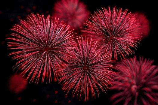 Red fireworks exploding in the night sky, creating vibrant bursts of color and light, illuminating the dark backdrop with stunning visual effects and festive atmosphere photo