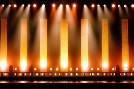 Professional event stage setup featuring amber lighting and tall illuminated panels, creating a vibrant atmosphere for presentations and performances with copy space photo