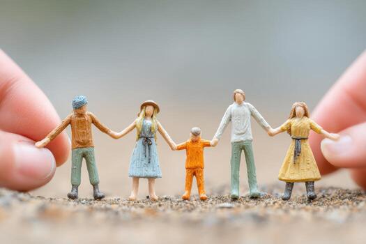 Miniature figures of a refugee family holding hands, symbolizing unity and support, with helping hands in the background, conveying a message of hope and compassion photo