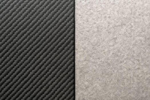 Dark woven carbon fiber meets soft gray felt creating gentle contrast that draws attention to pattern texture warmth and strength in a simple pairing suited to product design craft and quiet elegance photo