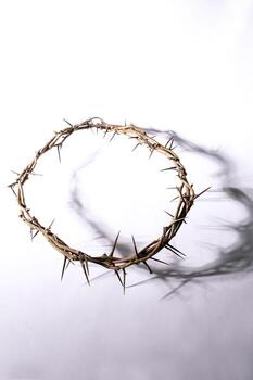 Jesus Crown of thorns casting a distinct shadow for Christian background, Easter concept creating a symbolic image of suffering, sacrifice, for space remembrance Copy text photo