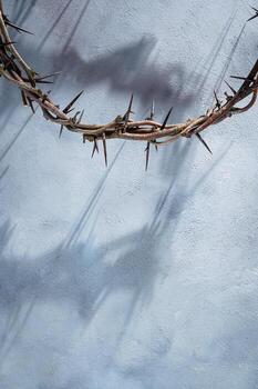 Jesus Crown of thorns casting a distinct shadow for Christian background, Easter concept creating a symbolic image of suffering, sacrifice, for space text remembrance Copy photo