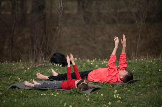Relaxing in nature a joyful afternoon of stretching and playing on grassy fields, surrounded by greenery, during a peaceful spring day in the countryside photo