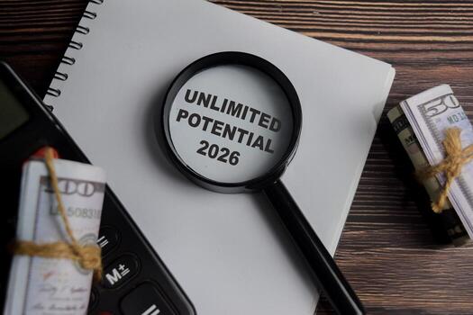 Concept of unlimited potential 2026 write on book with keywords isolated on Wooden Table. photo