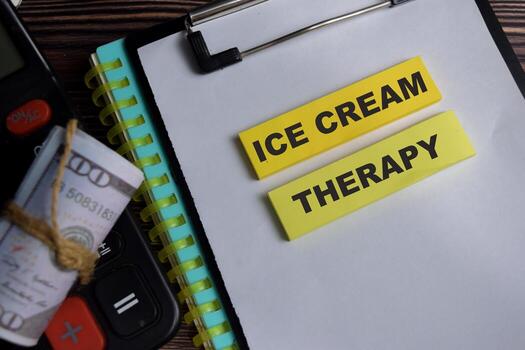 Concept of ice cream therapy write on sticky notes isolated on Wooden Table. photo