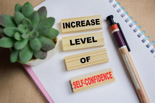 Increase level of self-confidence on stacked wooden cubes on the table. Business and finance concept photo