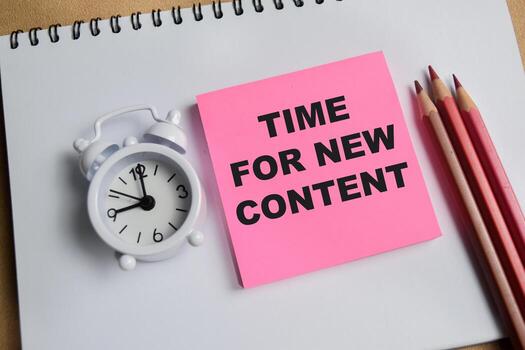 Concept of time for new content write on sticky notes isolated on Wooden Table. photo