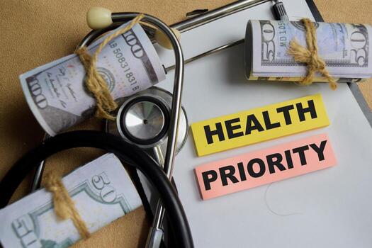 Concept of health priority write on sticky notes isolated on Wooden Table. photo