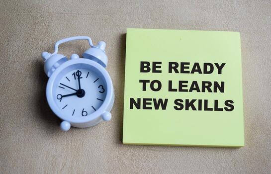 Concept of be ready to learn new skills write on sticky notes isolated on Wooden Table. photo