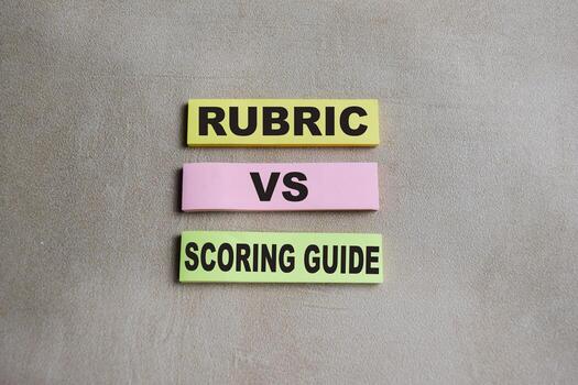 Concept of rubric vs scoring guide write on sticky notes isolated on Wooden Table. photo