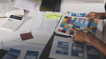 A person is working on a computer with a calculator and other items video