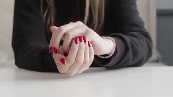 Female with red manicure gathering metallic coins and transferring them between palms while shaking, playful money handling activity captured in closeup. video