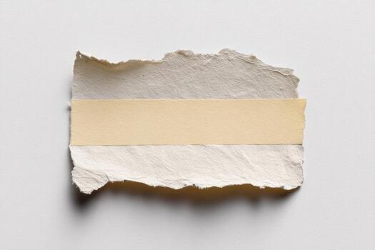 Torn paper scrap with beige tape center on white photo