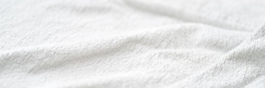 Soft white textured fabric close-up with gentle wrinkles and smooth surface for design and background concepts. photo