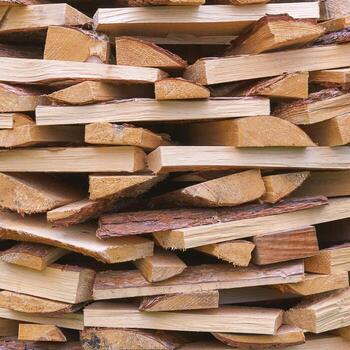 Stack of split firewood with rough texture and natural variations in color and grain patterns. photo