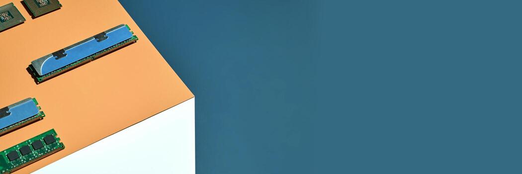 Computer memory modules and processors on corner against blue background tech hardware overview. photo