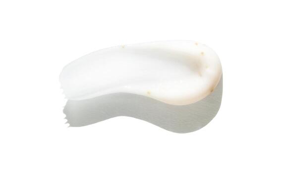 Close-up of white cream texture on white background with soft shadows and smooth curves. photo