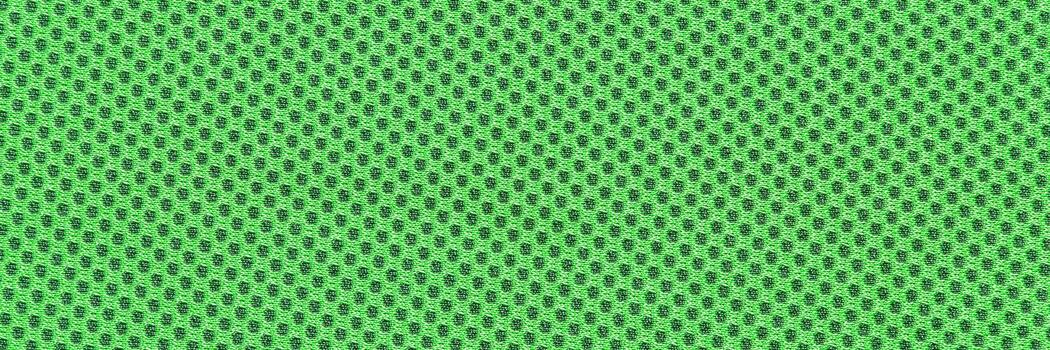 Close-up of green fabric with detailed mesh texture pattern in vibrant shade. photo