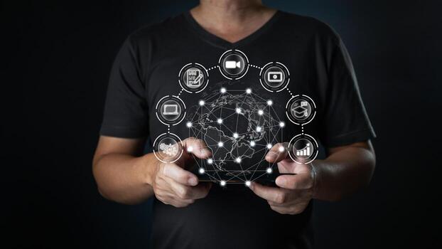 A person holding a digital tablet with a holographic globe surrounded by icons representing business, connection, networking, and digital tools, highlighting global interconnectedness. photo