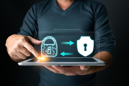 Secured connection. A user interacts with a tablet displaying a lock and shield, symbolizing secure data transfer and protection against cyber threats. photo