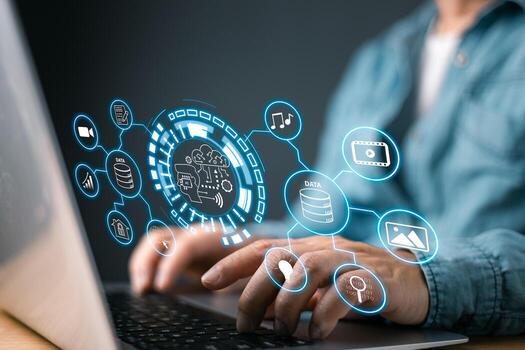 A person works on a laptop with a holographic interface displaying AI, data storage, and multimedia icons, representing digital transformation, smart technology, and big data management systems. photo