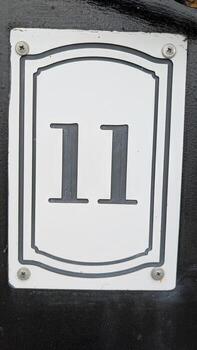 The number 11 is prominently featured on a stark black background, creating a striking visual photo