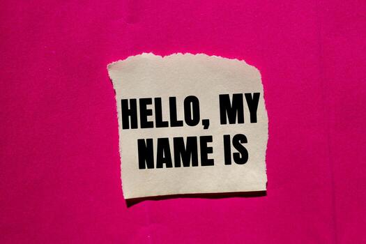 Hello, my name is message written on ripped torn paper piece on pink background. Conceptual Hello, my name is symbol. Copy space. photo