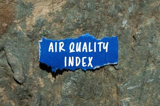 Air Quality Index message written on ripped torn blue paper on stone background. Conceptual Air Quality Index symbol. Copy space. photo