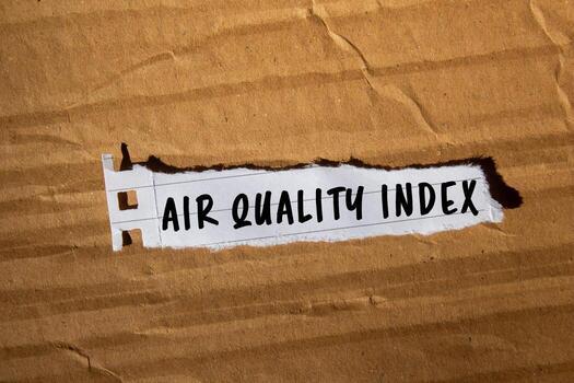 Air Quality Index message written on ripped torn lined paper on cardboard paper background. Conceptual Air Quality Index symbol. Copy space. photo