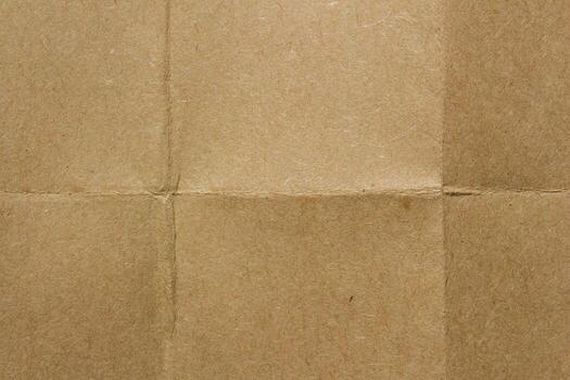 Kraft paper texture with fold lines. Detailed cardboard surface showing intersecting creases and natural fiber patterns. photo