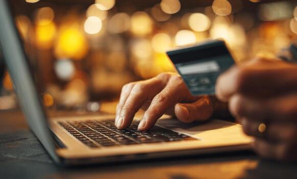Person typing on laptop keyboard, making online payment photo