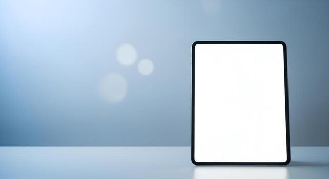 Modern vertical tablet screen mockup on a clean white desk with a soft blue gradient background and wide copy space. Ideal for app design and digital concepts photo