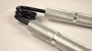 A set of hand grippers is displayed on a rotating background. video