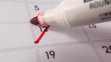 highlighting datum siffra 12 på en kalender, med en djärv röd korsa mark video