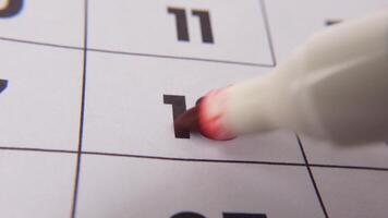 Highlighting date number 18 on a calendar, with a bold red cross mark emphasizing an important reminder or scheduled event. video