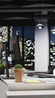 Vertical Empty modern workspace at night with infographics and pc devices at workstation, business office used for company management and administration. Digital tools for forecasting. video