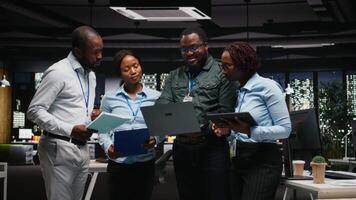 Black corporate staff working together on report writing in the office, collaborating on building a new development strategy. Reviewing insights to enhance efficiency and progress. Camera A. video