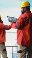 Vertical Drilling rig ship employee using tablet app to monitor equipment systems. Offshore installation manager calibrating gear with touchscreen device application, doing maintenance, camera A video