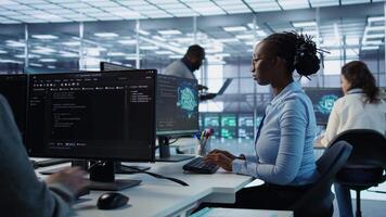 Portrait of smiling woman tasked with doing checkup on server room rows providing computing resources for different workloads. Happy admin investigating data center mainframes using PC, camera B video